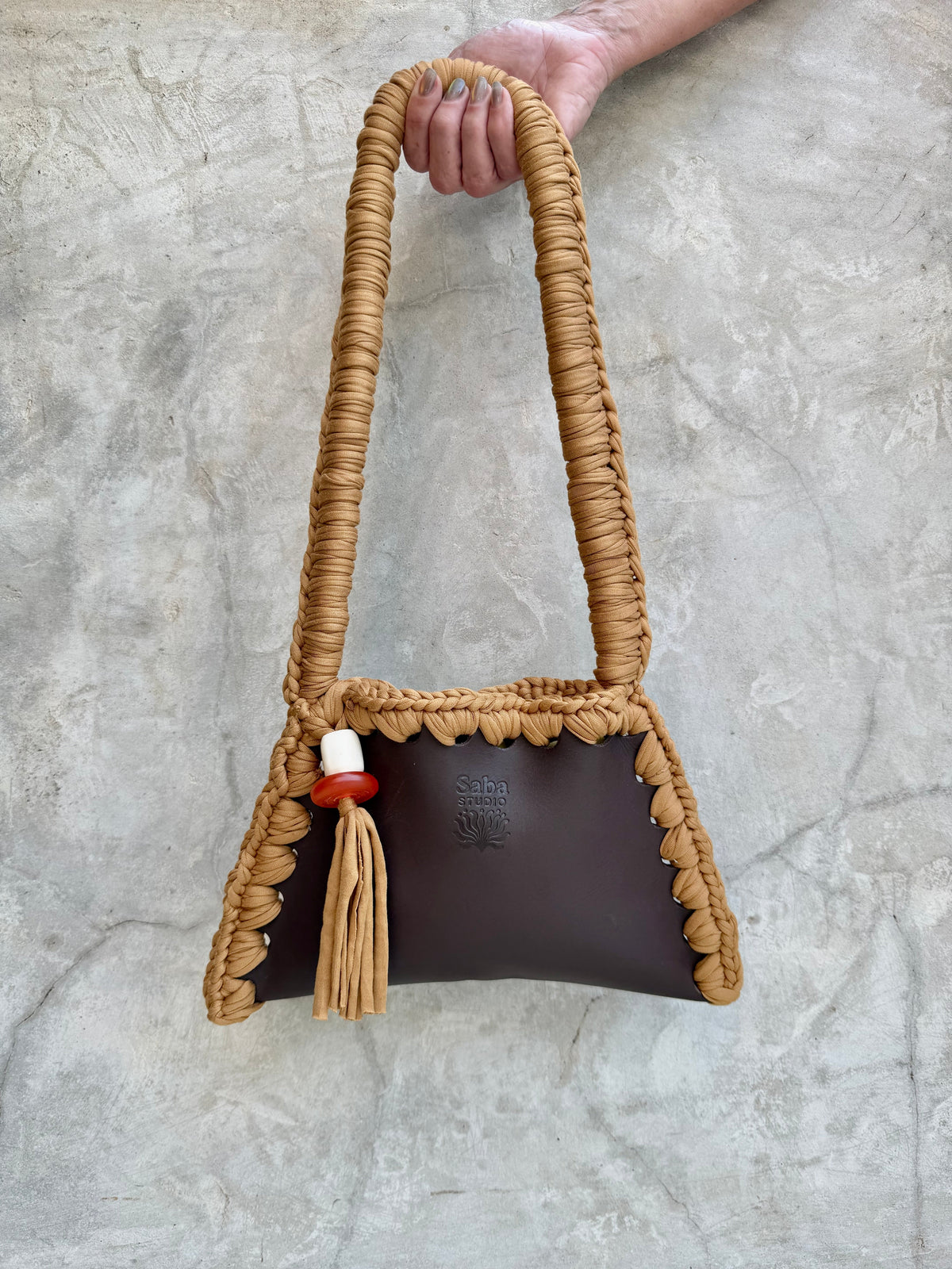 Saba Studio Solara shoulder bag in tan repurposed textile with red and white bead, full view